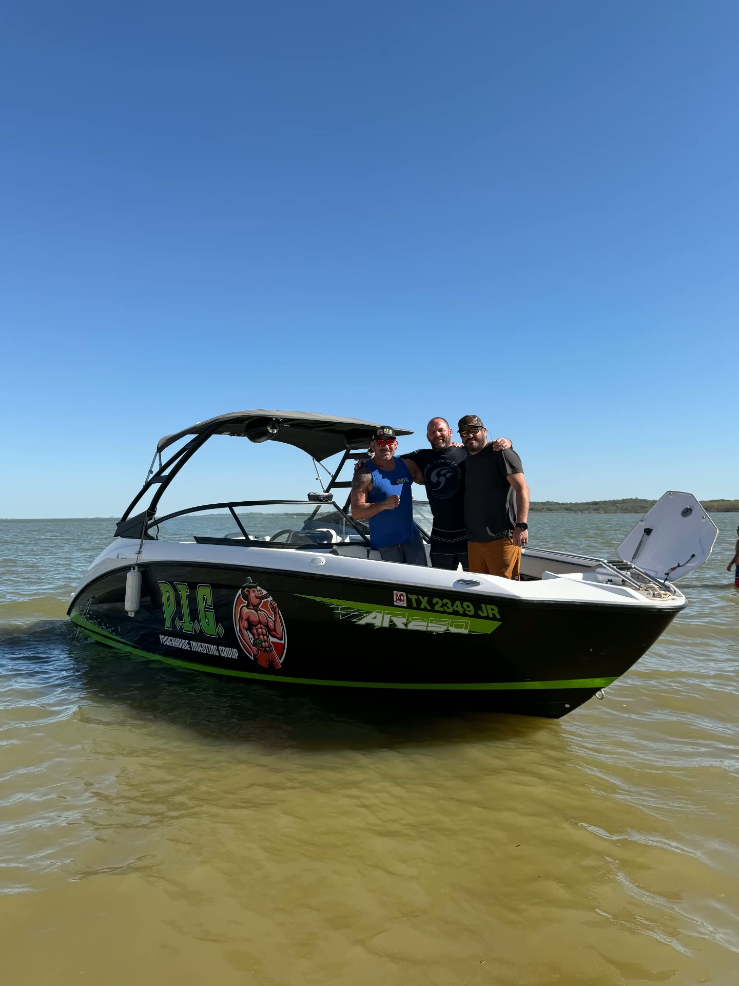 P.I.G.-wrapped boat on the water with members