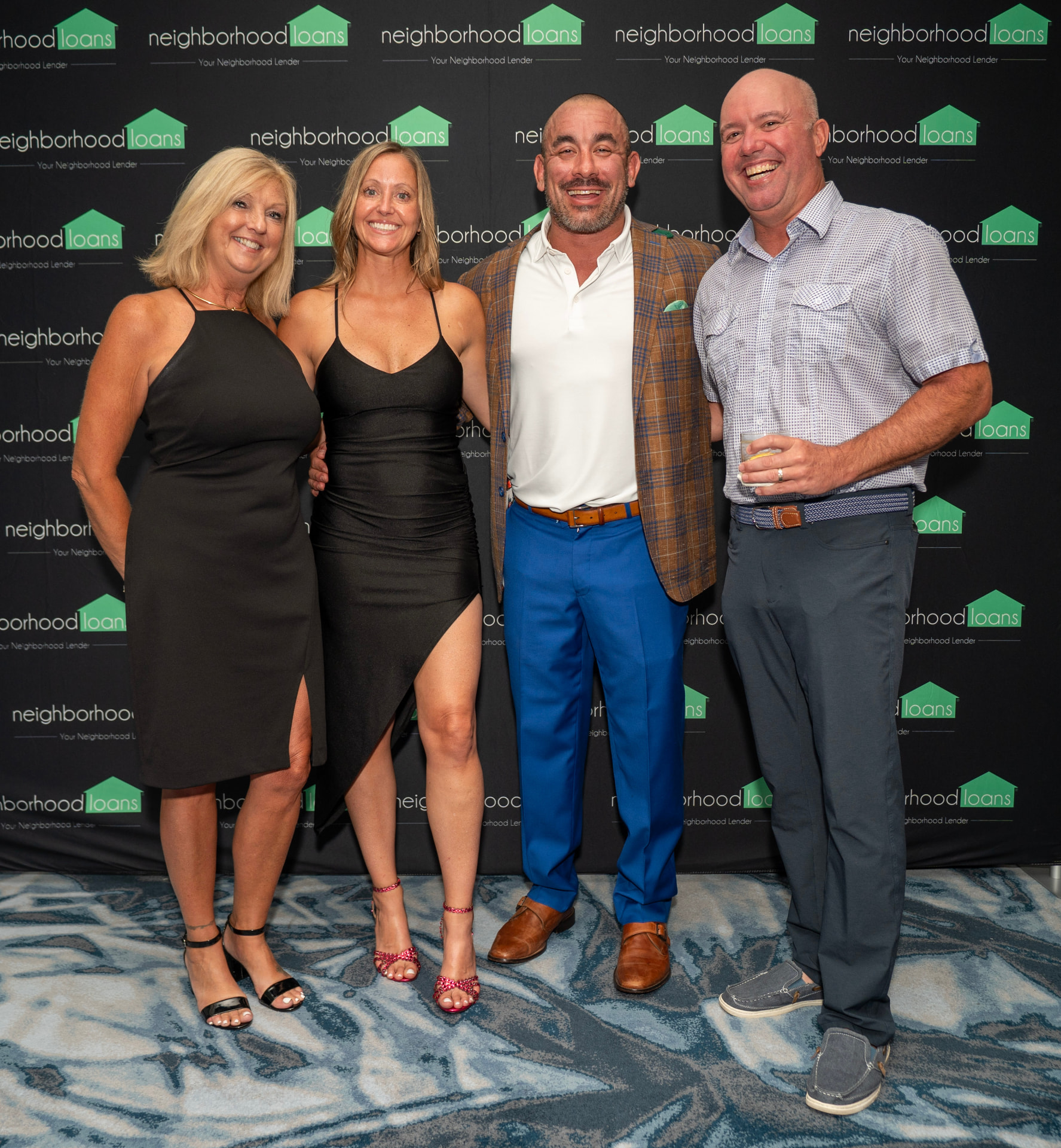 P.I.G. members at the Neighborhood Loans backdrop