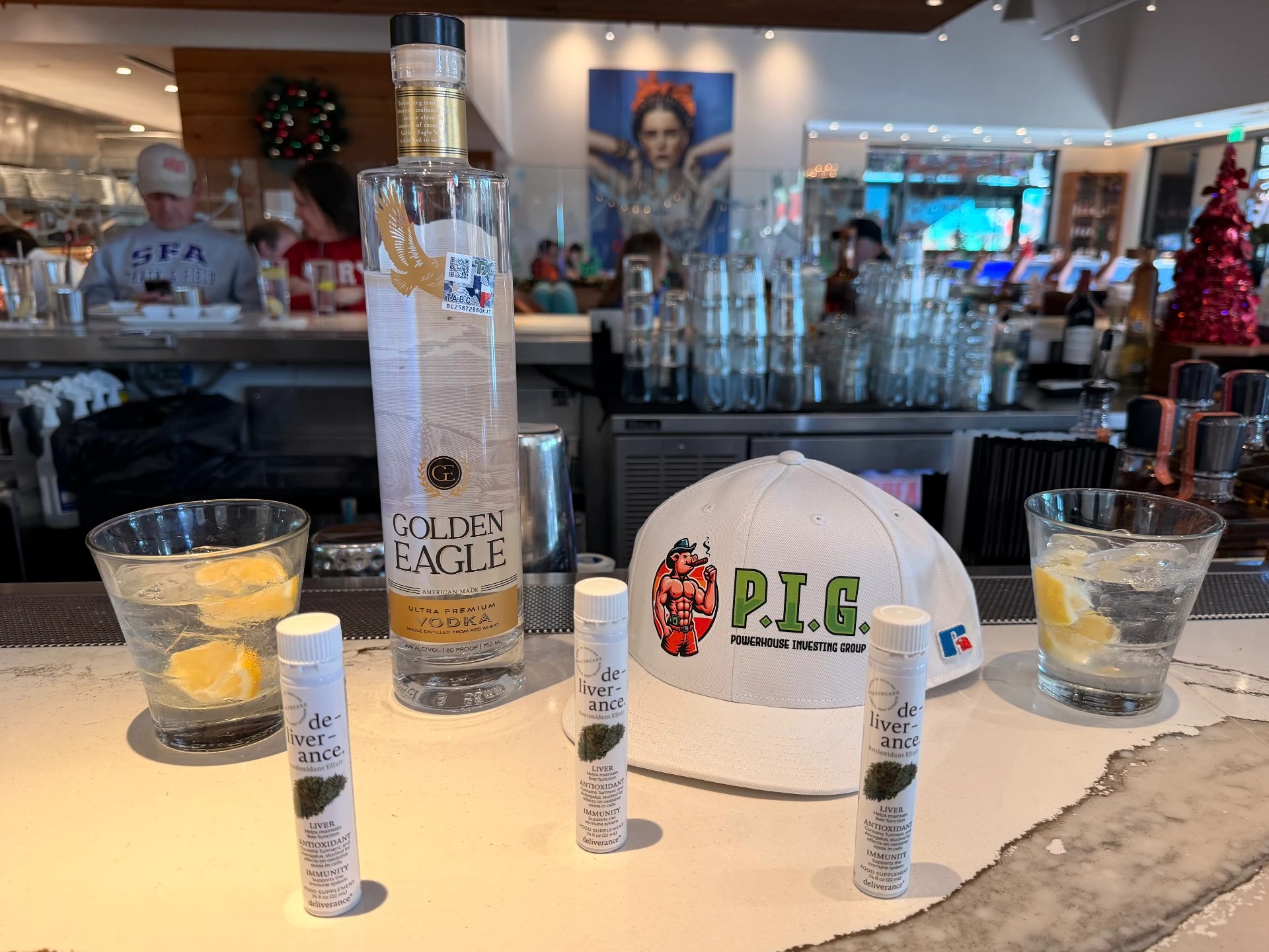 Golden Eagle Vodka, De-Liver-Ance elixirs, and a P.I.G. hat at the bar